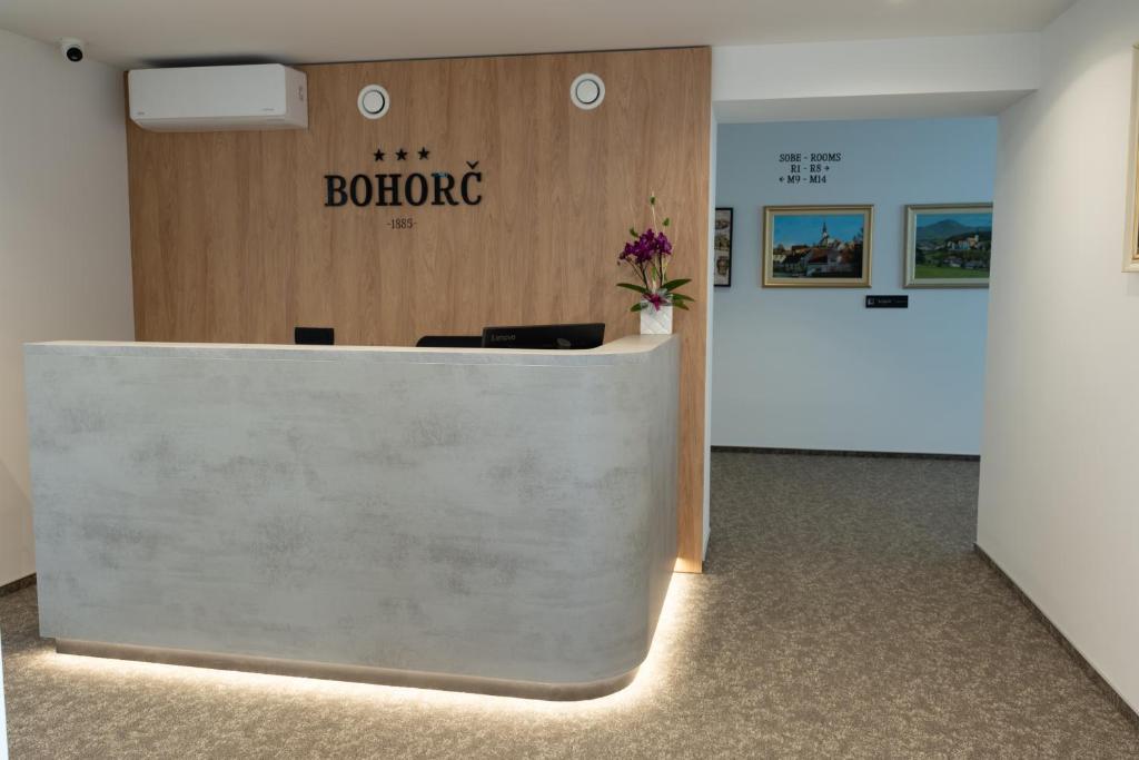 Recepcija prenočišč Bohorč z leseno steno in napisom
